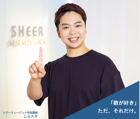 人差し指を立てている男性